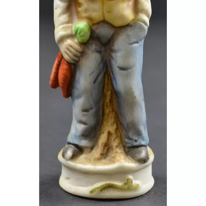 Man In Hat Leaning On A Log Ceramic Fguine - 4.75" Tall