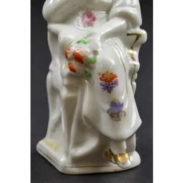 Woman Wearing A White Bonnet Sitting In Chair Ceramic Figurine - 5 Tall